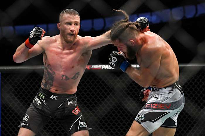 Justin Gaethje throws a punch at Rafael Fiziev during their UFC 286 clash.